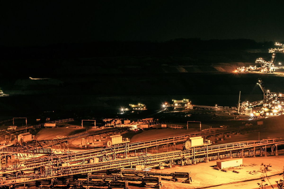 Aerial view of illuminated mining operations at night in Inden, Germany.