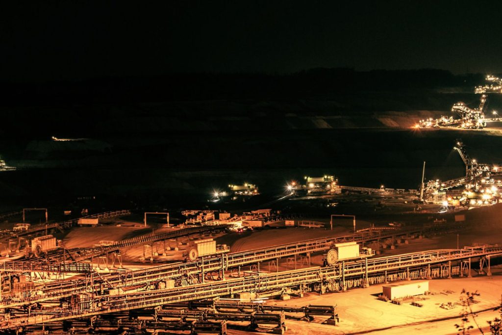Aerial view of illuminated mining operations at night in Inden, Germany.
