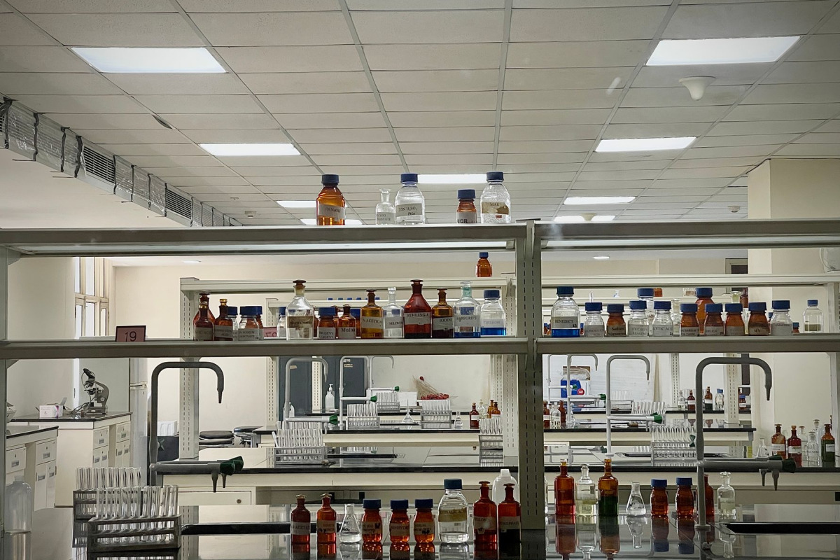 A detailed view of a modern science lab with chemical bottles and test tubes.
